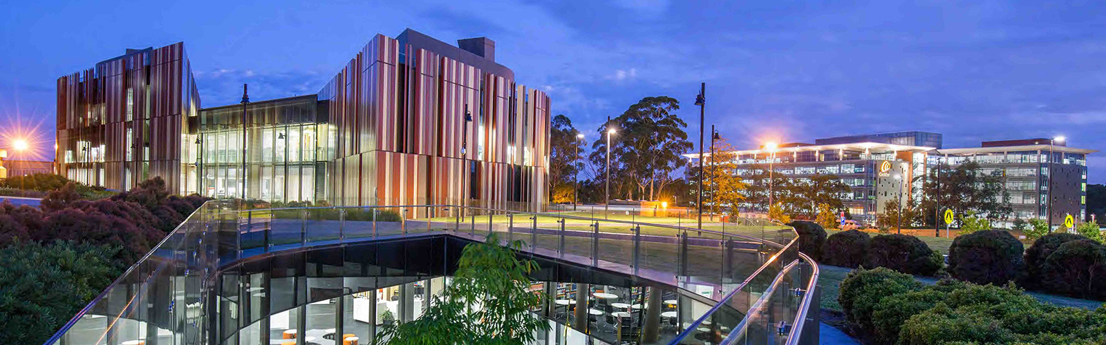 Modern university building at night.