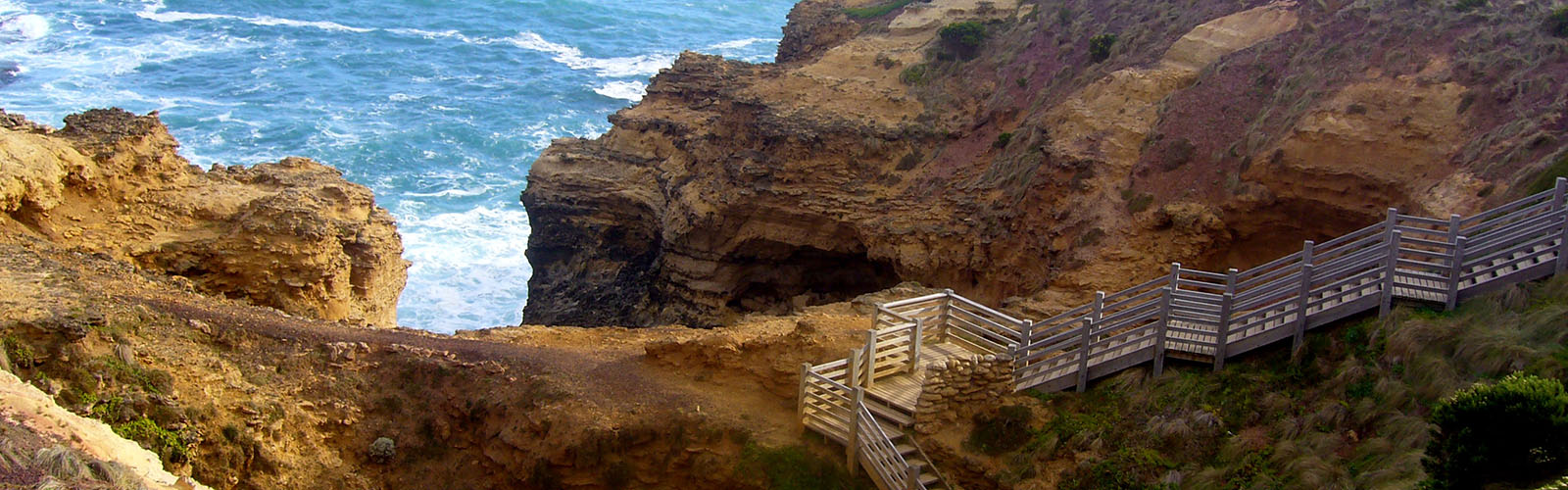 Water is hitting luscious cliffs.