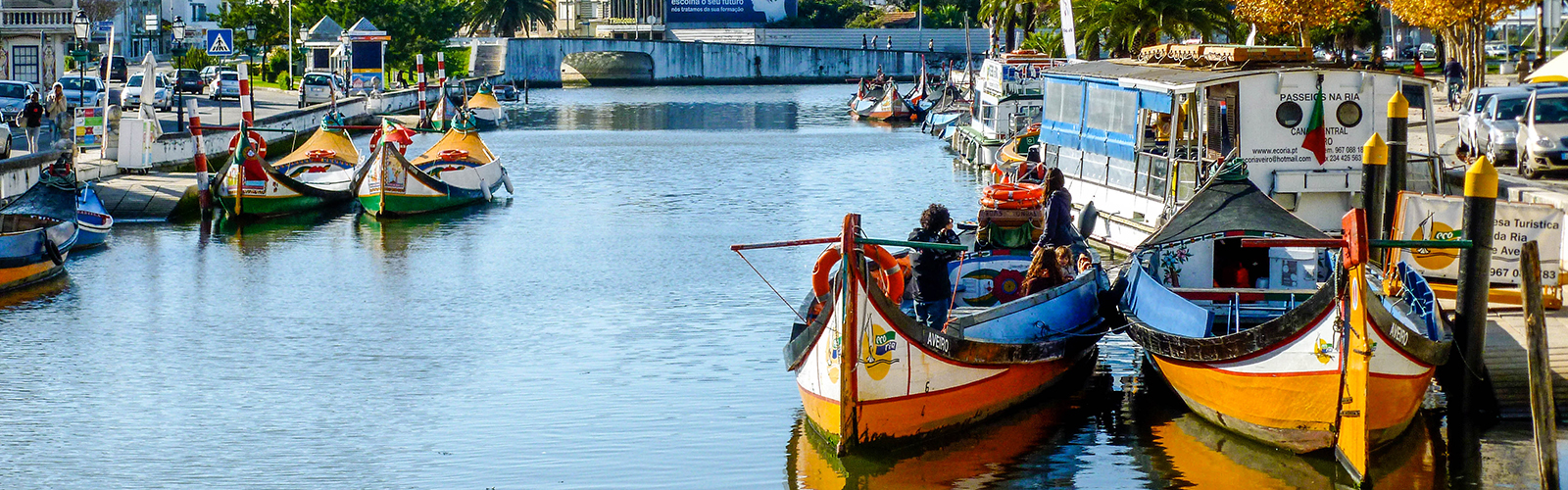 Brightly colored boats floating in a narrow waterway.