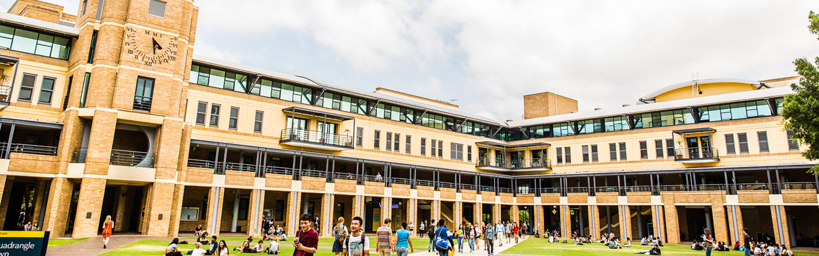 Students are gathered in the courtyard space of a university building.