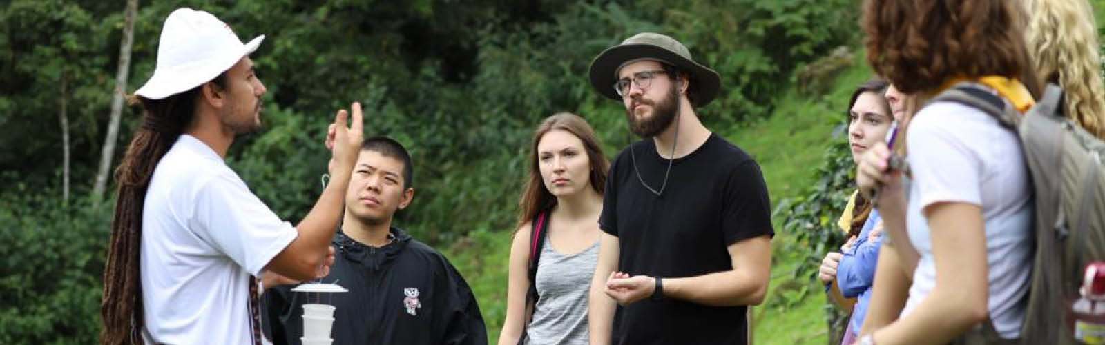 An instructor is giving directions to students. The students are attentive and looking at the instructor.