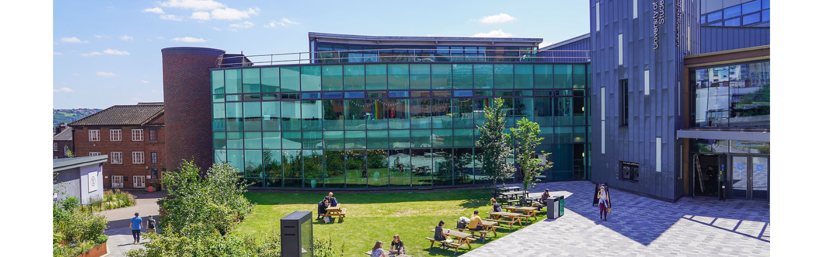 Exterior of a university building, highlighting the modern architecture with massive windows.	