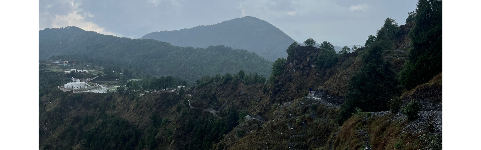 Three mountains in varying distance from the camera are covered in greenery.