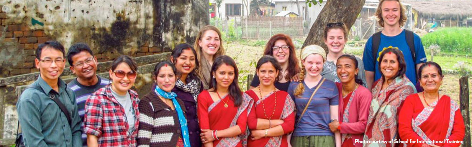 A group of students and citizens pose smiling for the camera. 