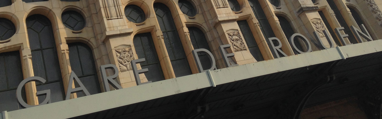 Exterior of one of the university buildings. There are words on the building that read "Gare de Rouen". The architecture is old and detailed.