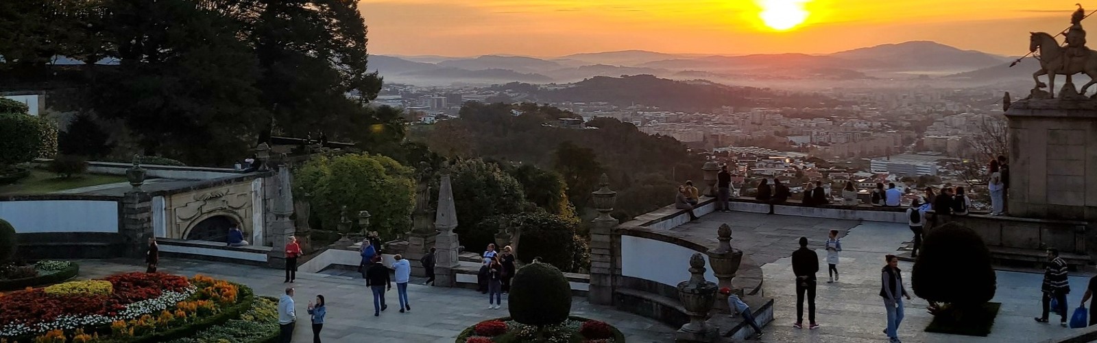 View of Lisbon at sunset from terraced gardens overlooking the city.