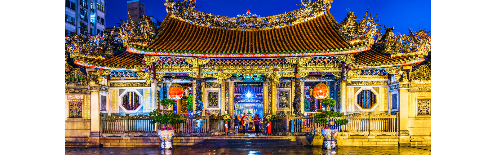 Taipei's ornate Longshan Temple, lit brightly at night.