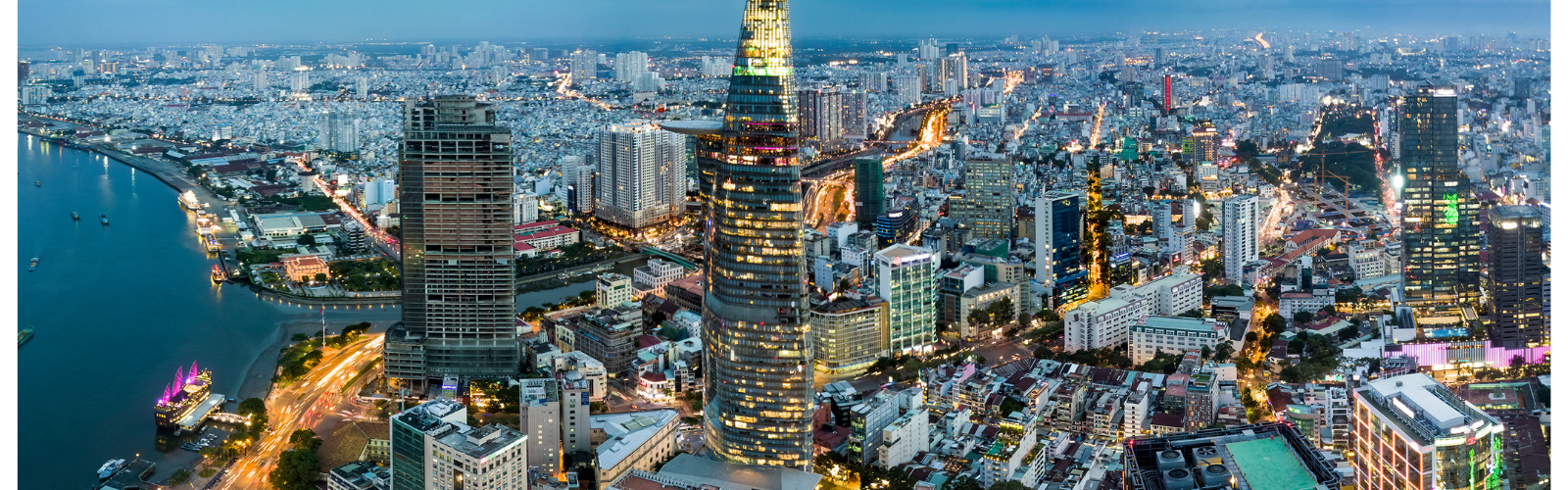An aerial view of Ho Chi Minh City, lit up brightly at dusk.